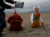 clapper board and ladies in sand